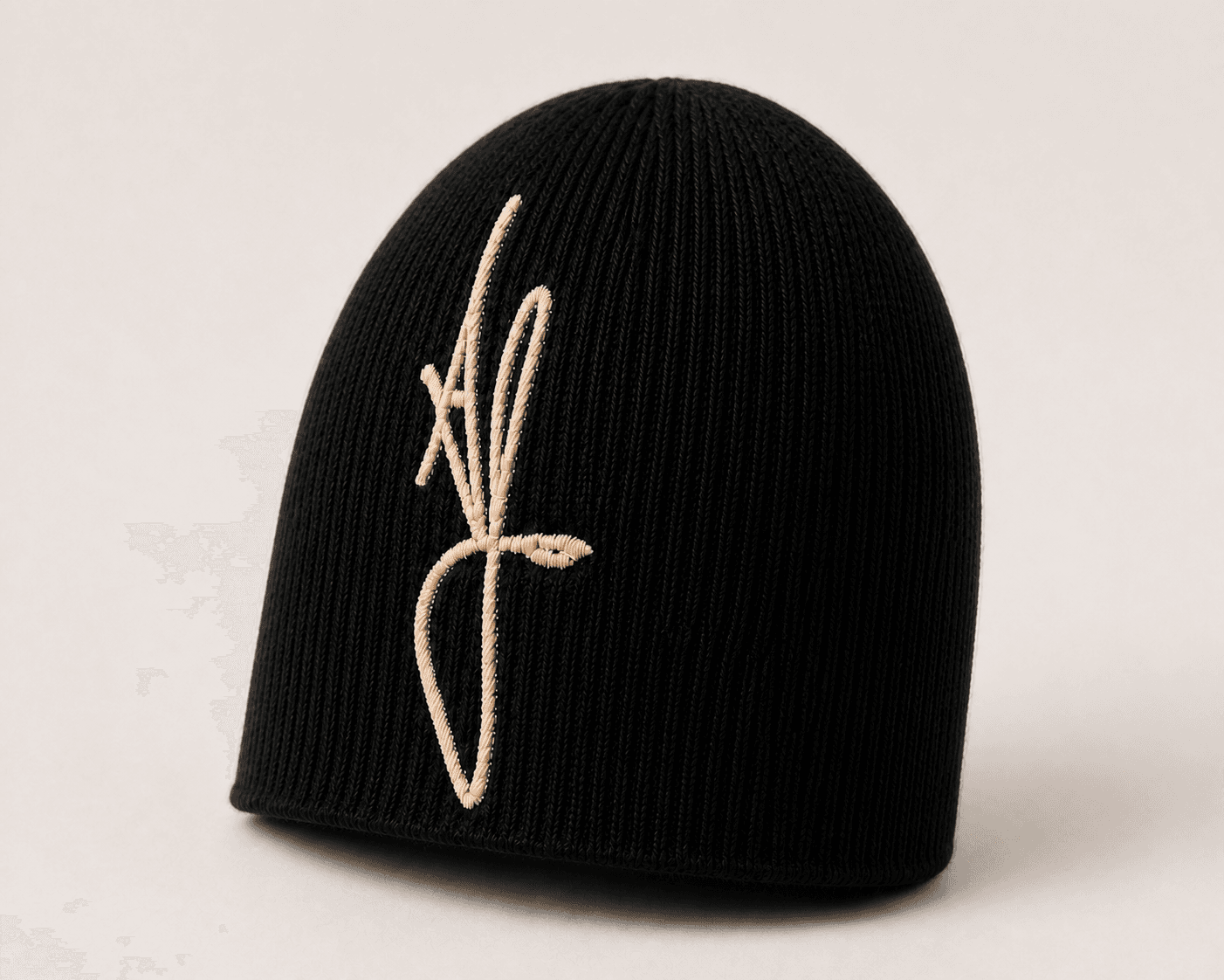 Nūr Signature Beanie in Noir, skully front three-quarter view